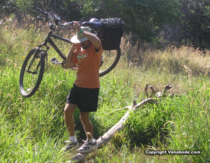 Picture of Jason carrying bike over water